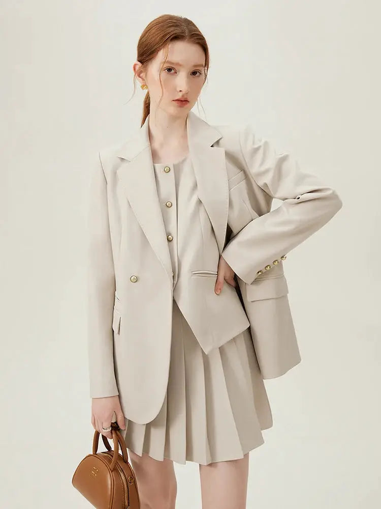 Beige women's blazer suit set with pleated skirt and gold-tone buttons