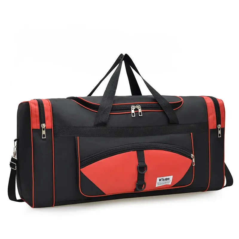 Oversized travel handbag by Simples Market with black body and red panels, dual top handles and detachable strap