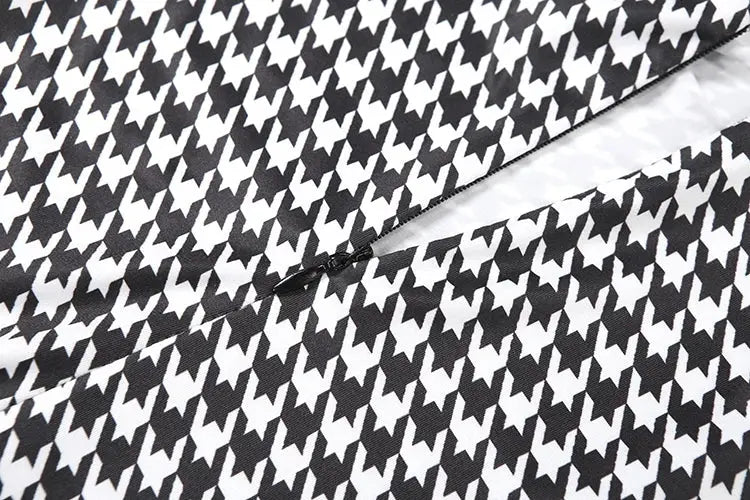 Jumpsuit fabric in black-and-white houndstooth pattern with visible seam detail