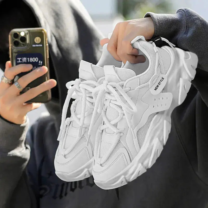 Pair of white men's breathable sneakers with thick soles for outdoor casual running.