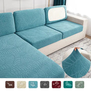 Three teal waterproof stretch seat cushion covers for sofas with leaf-pattern fabric by Simples Market