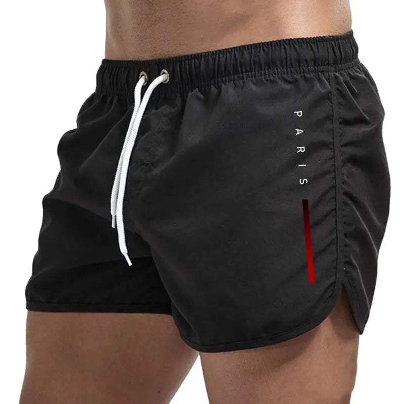 Men's black board shorts by Simples Market with white drawstring and PARIS logo