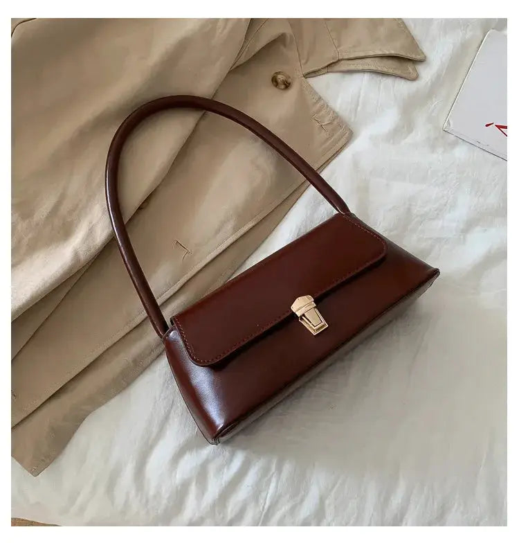 Shoulder bag in brown leather with retro style, top handle and gold-tone clasp