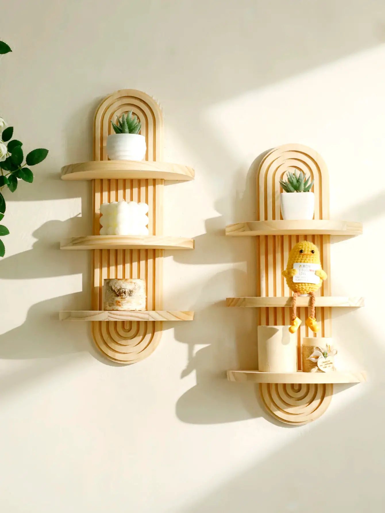 Two boho-style wooden wall shelves with arched geometric design and natural finish