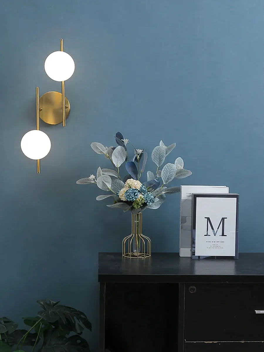 Simples Market gold LED wall lamp with two milky-glass round globes and G9 bulbs.