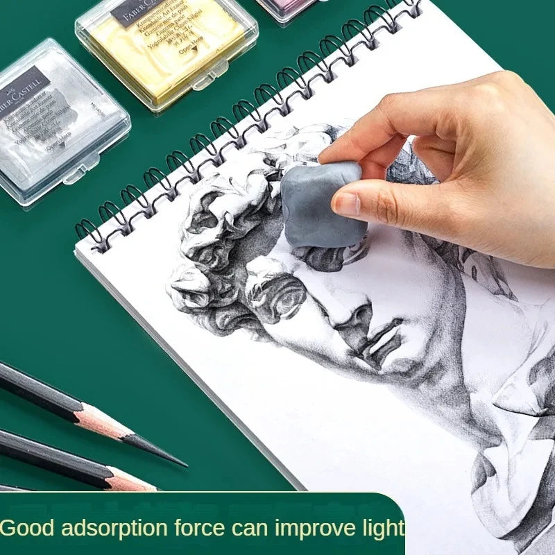 Faber-Castell Plasticity kneaded eraser held over a grayscale statue sketch on a spiral notebook; three eraser boxes visible