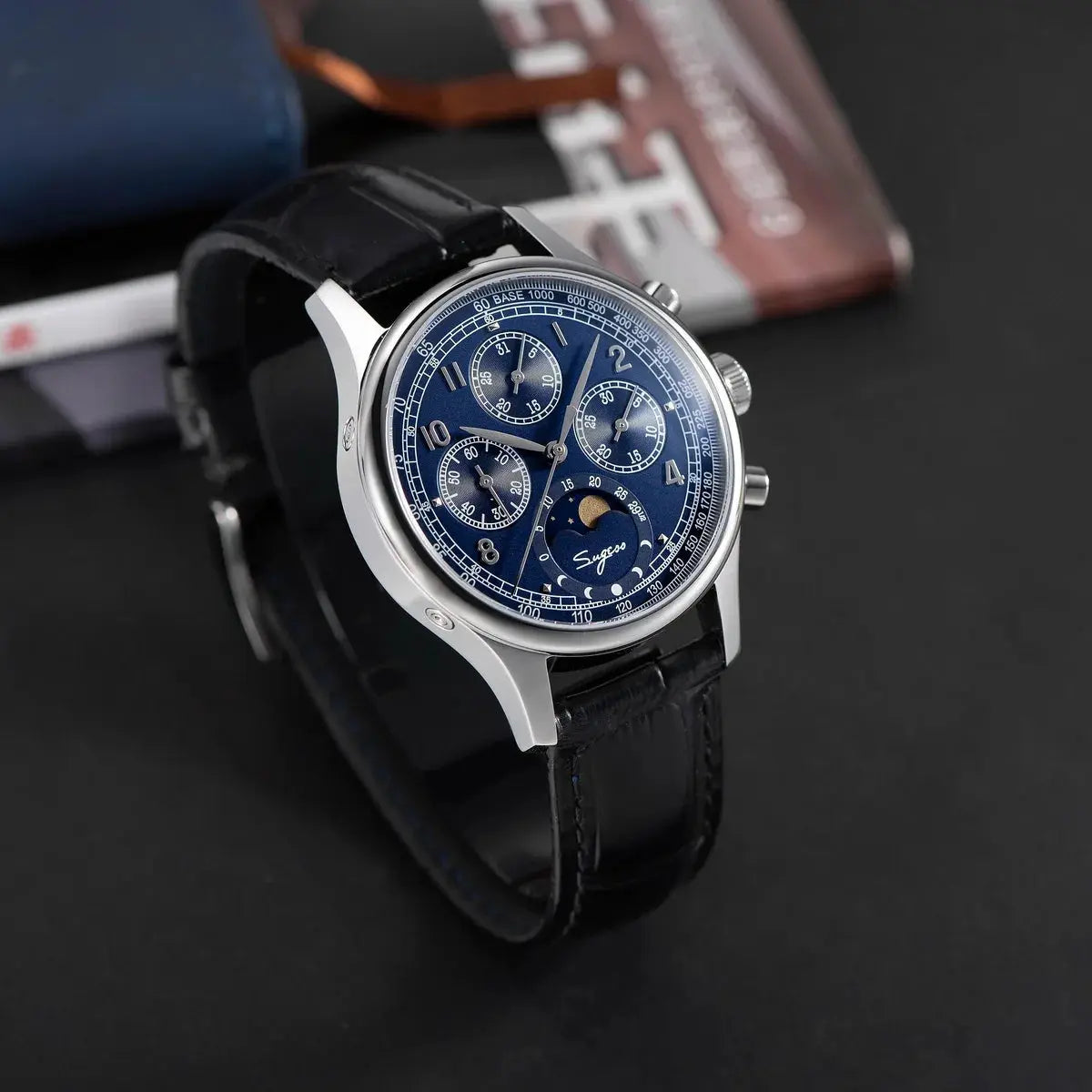 Sugess men's chronograph wristwatch with blue dial and moonphase display