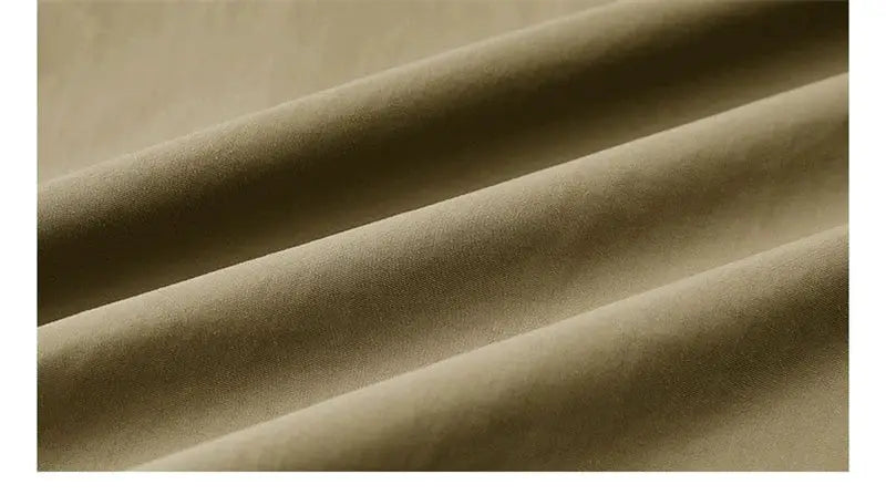 Men's beige vest fabric close-up, solid textile texture