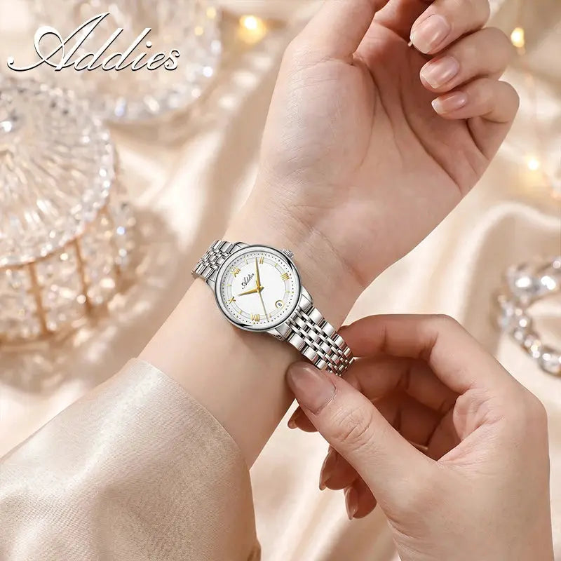 Addies luxury women's stainless steel wristwatch with sapphire glass, 31mm case, white dial with gold-tone markers.