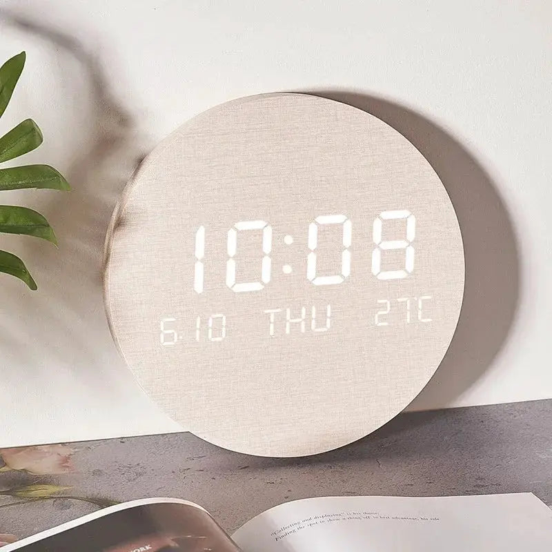 Beige round fabric-textured LED digital wall clock showing time, date, day and temperature.