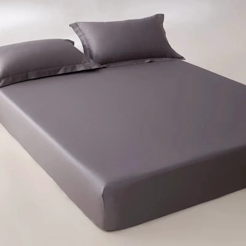 Egyptian cotton fitted sheet by Simples Market in grey with 2 pillows on bed