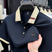 Navy short-sleeve polo shirt with beige monogram jacquard collar and bee embroidery, size 50.