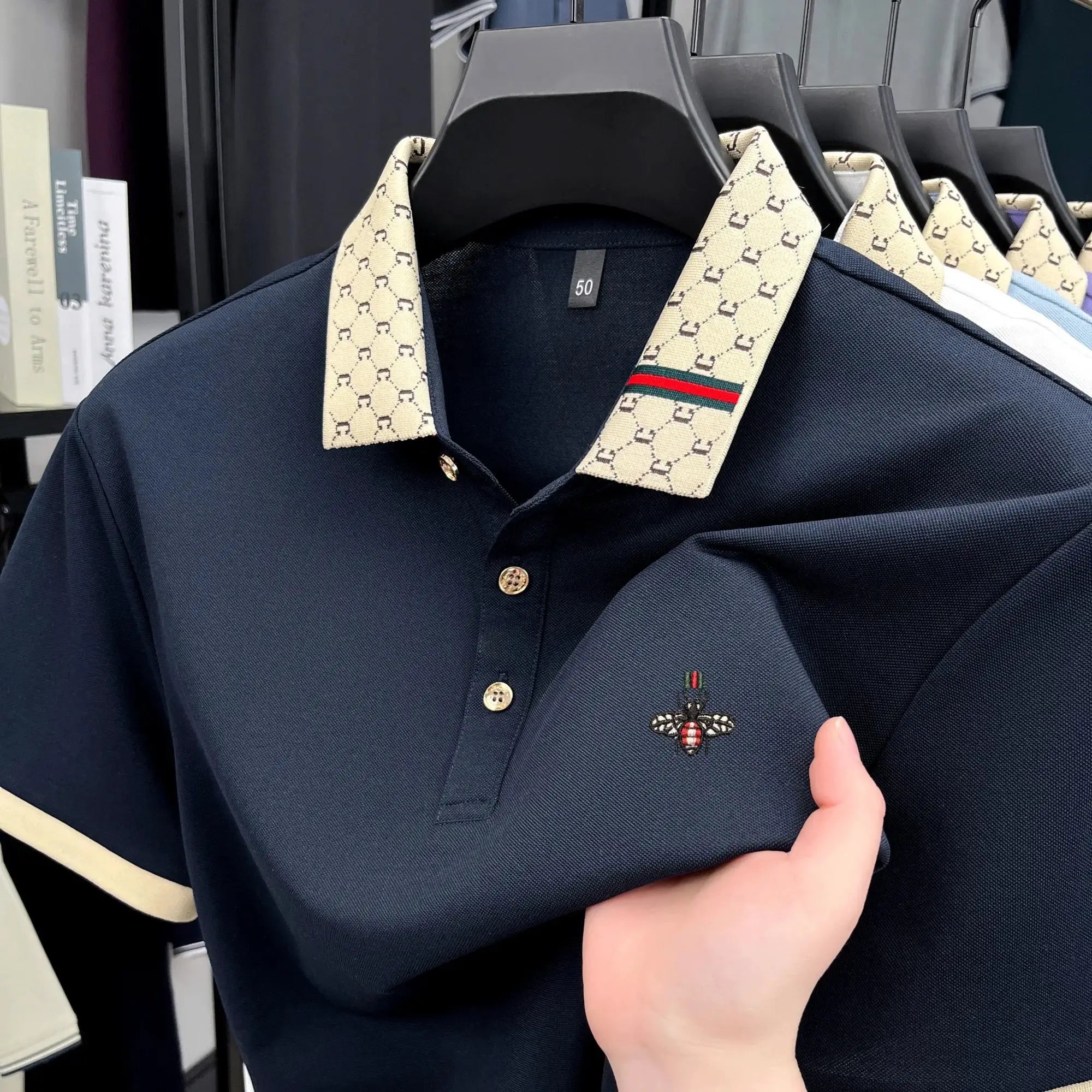 Navy short-sleeve polo shirt with beige monogram jacquard collar and bee embroidery, size 50.