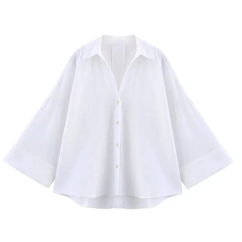 Women's white loose-fit button-up shirt with wide balloon sleeves and curved hem.