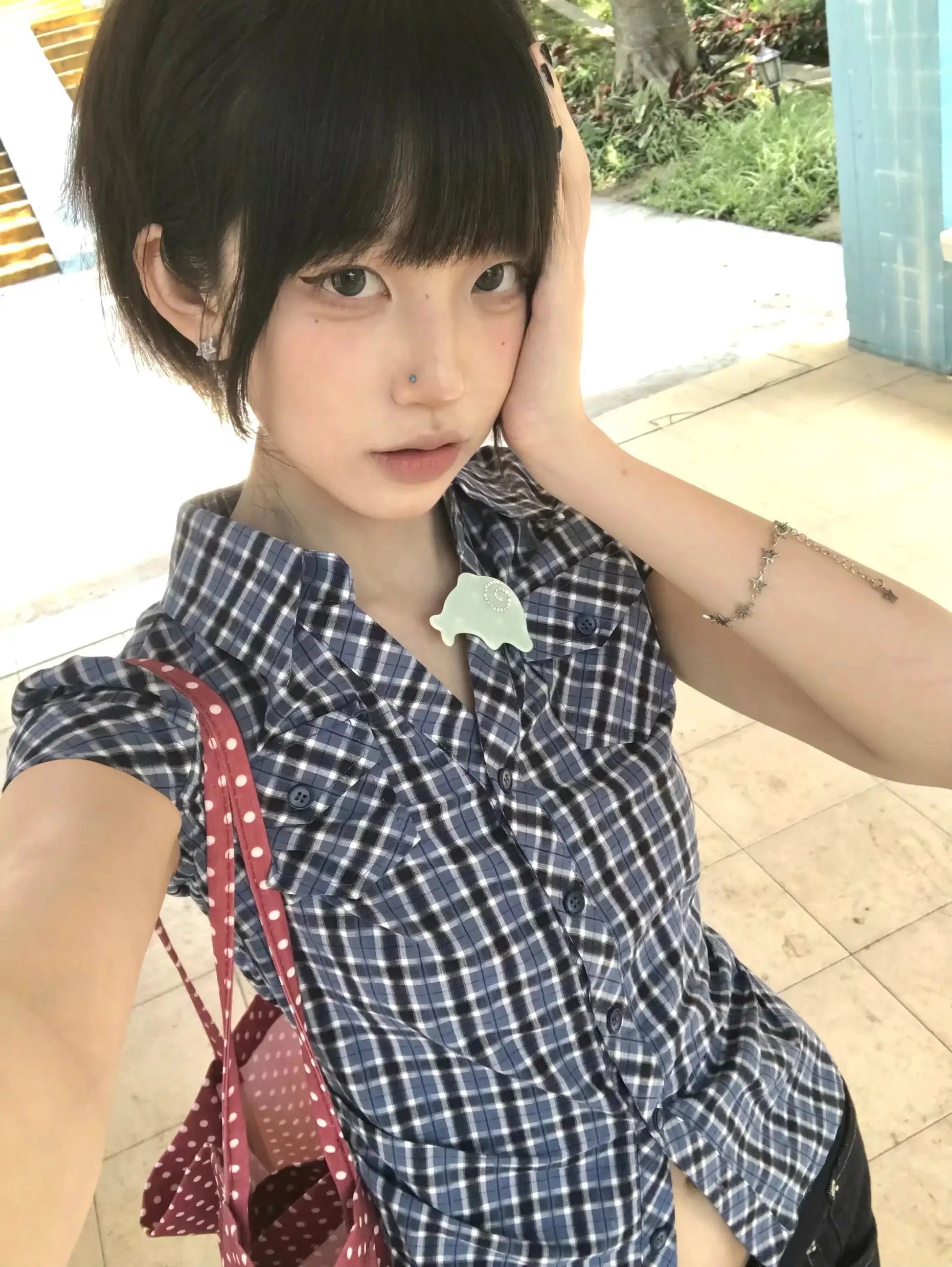Karrram navy plaid short-sleeve shirt with button-down front worn by a young woman; blue and white check