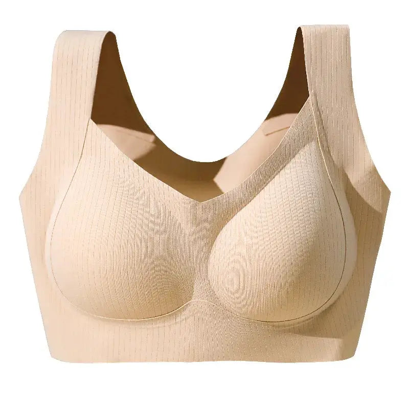 Nude one-piece bra with fixed molded cups and wide straps; seamless back sports vest style.