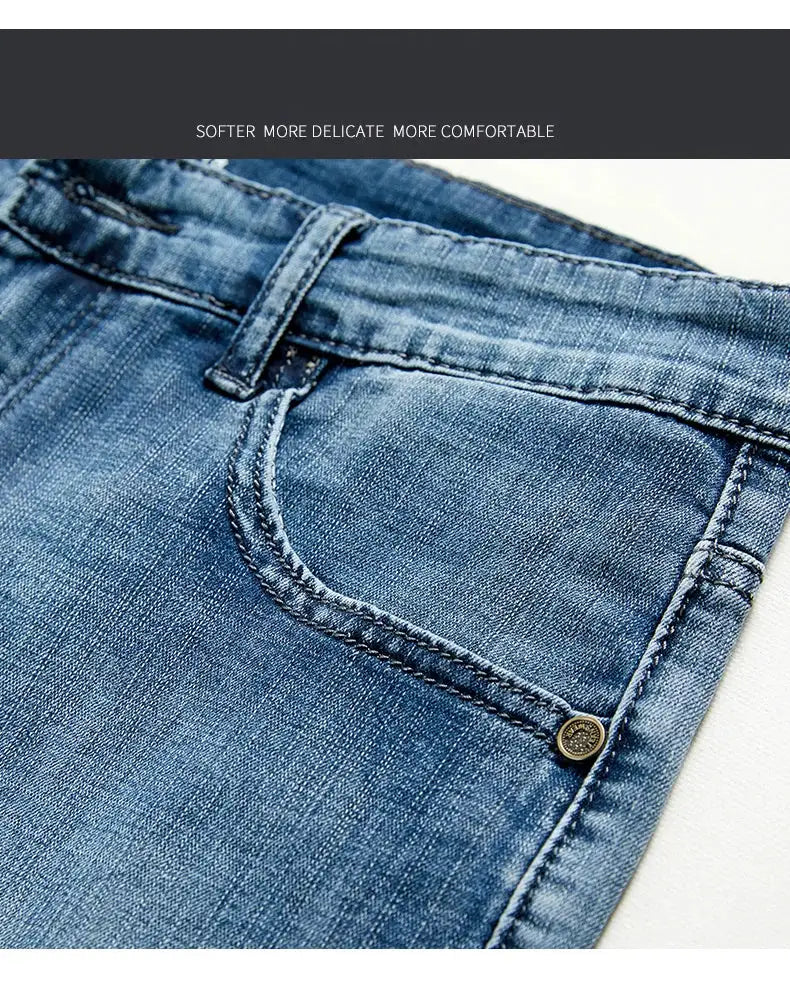 Men's slim blue denim shorts with front pocket, belt loop, and brass rivet