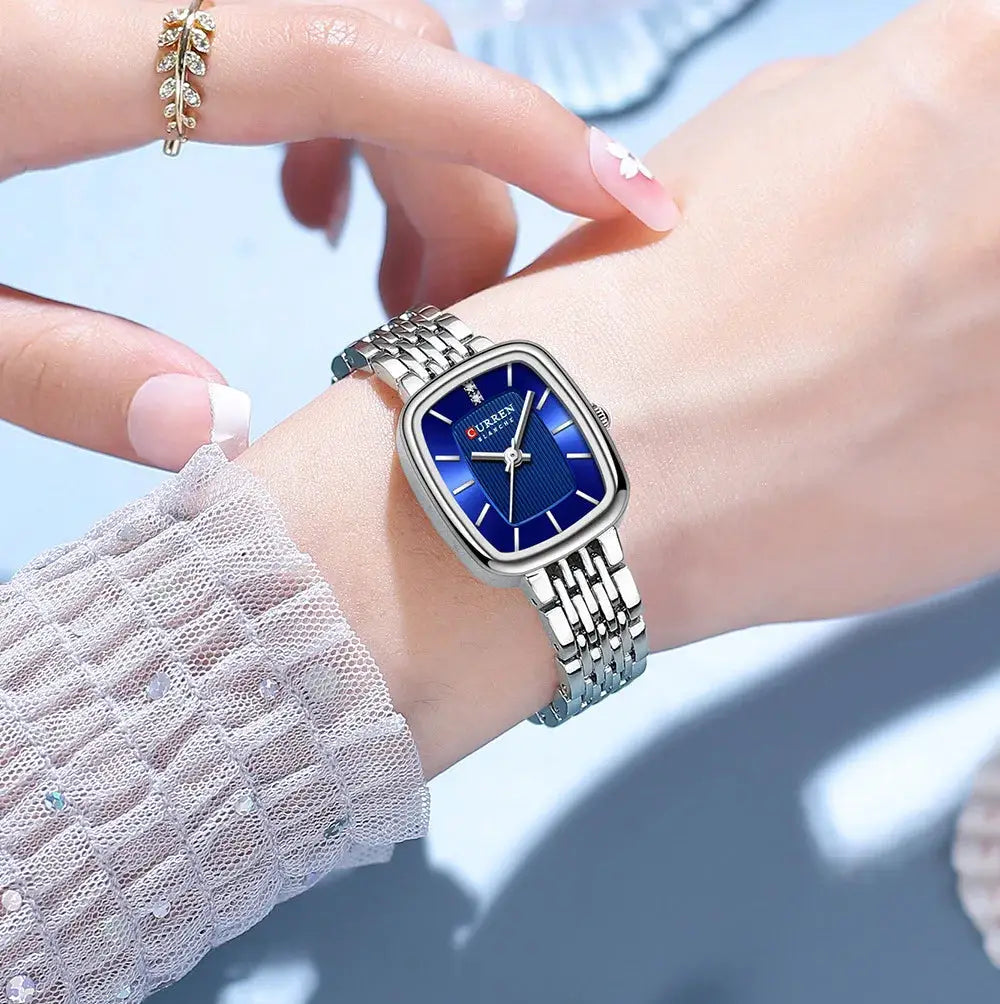 CURRN 9093 women's quartz watch with blue dial and silver stainless-steel bracelet.