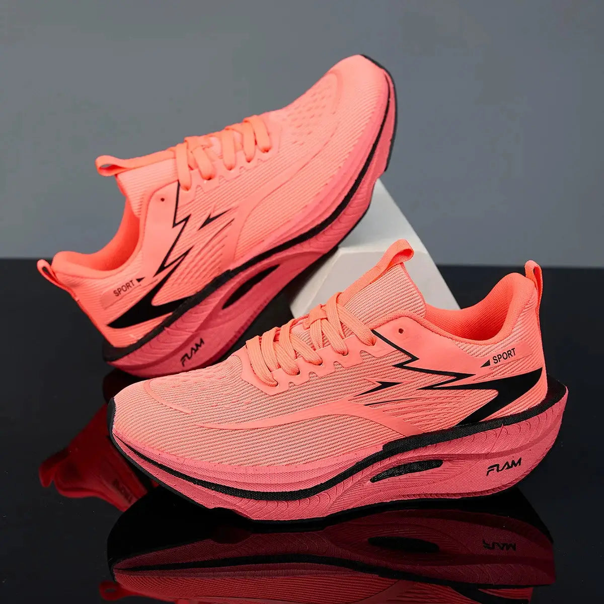 Pair of pink running shoes with breathable mesh upper and black nonskid sole