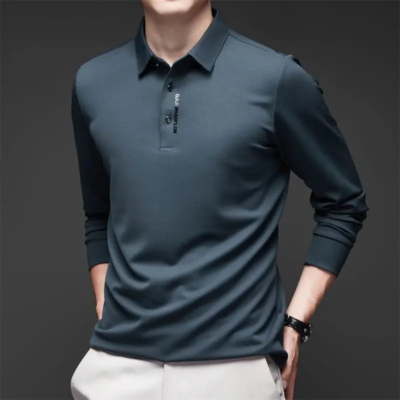 Men's polo shirt by Simples Market in dark teal; long sleeves with badge detail.