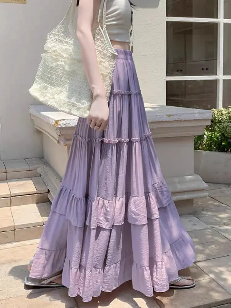 Tiered lavender maxi skirt with ruffle hem, high-waist chiffon layers, flowy A-line.