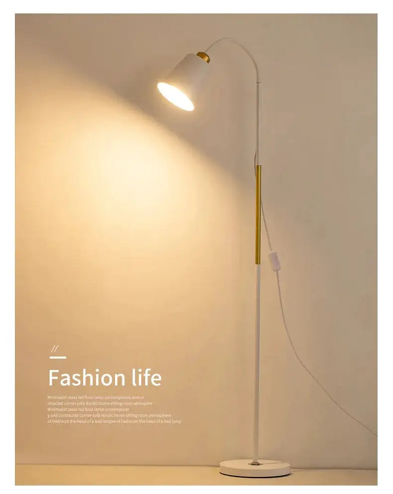Floor lamp with white stand and gold accents; adjustable LED lamp head for reading.