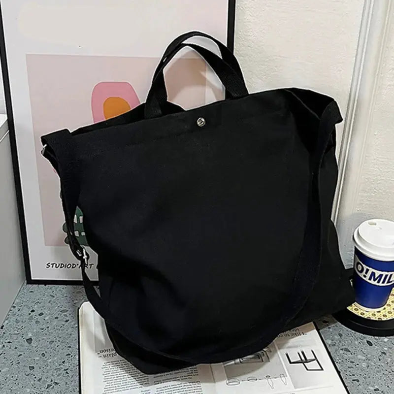 Simples Market canvas cross-body bag in black; large-capacity unisex satchel.