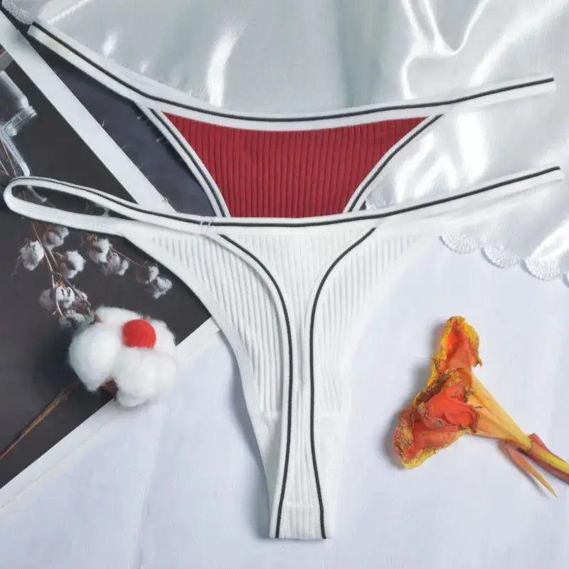Women's white seamless cotton thong with black trim and red front panel