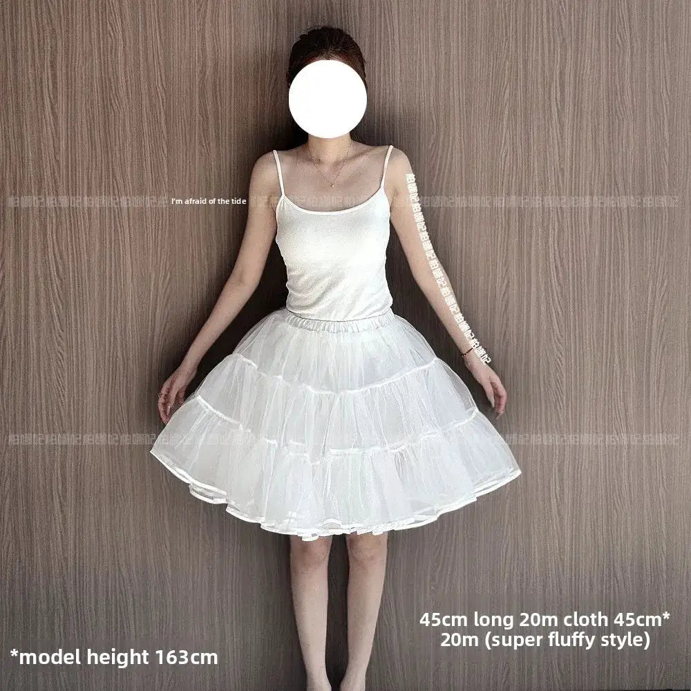 Lolita petticoat underskirt, white multi-layer tulle, worn by a model in a white tank top