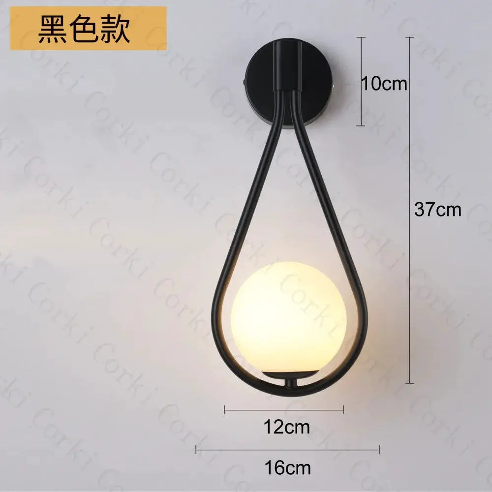 Nordic black metal glass-ball LED wall lamp with warm glow for living room.