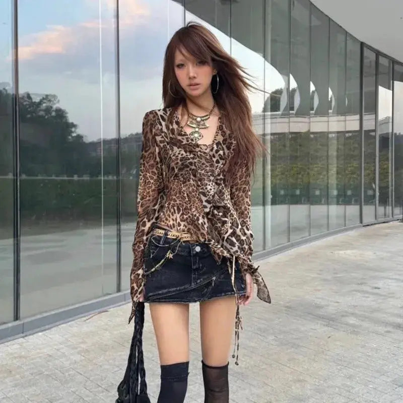 Leopard print long-sleeve wrap-style blouse with V-neck.