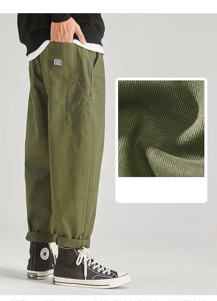 Olive green men's cargo pants with multiple pockets, baggy fit, and cuffed hems; belt loops, Simples Market streetwear.