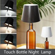 Two LED wireless bottle lamps by Simples Market; touch-activated lamps with black and white shades on brown wine bottles