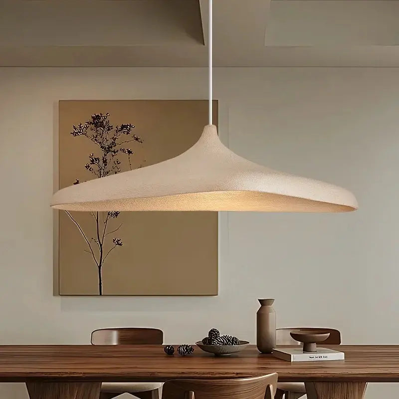 Japanese Wabi Sabi LED pendant lamp with beige textured shade over a wooden dining table.