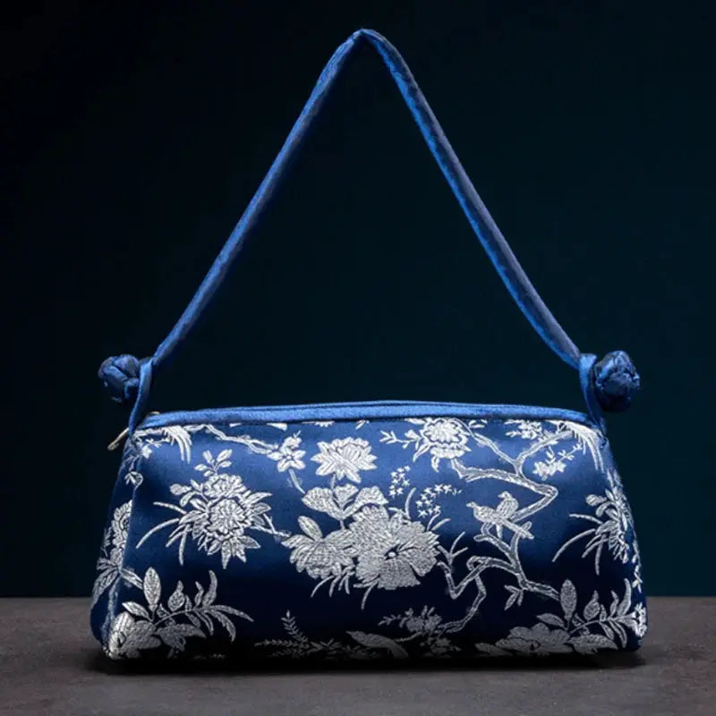 Shoulder bag in blue satin with silver floral embroidery and knotted strap