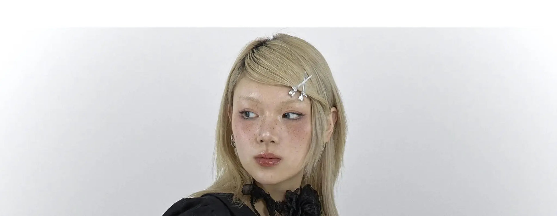 Karrcat Gothic black lace shirt on a blonde model with silver hair clips; dark lace top