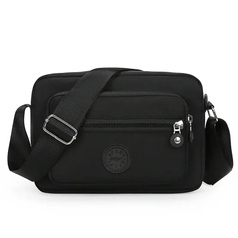 Black crossbody bag with front zip pocket and adjustable shoulder strap