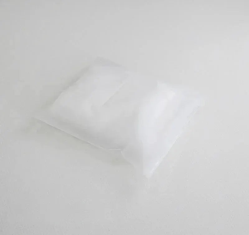 White cervical pillowcase in clear packaging on a white surface