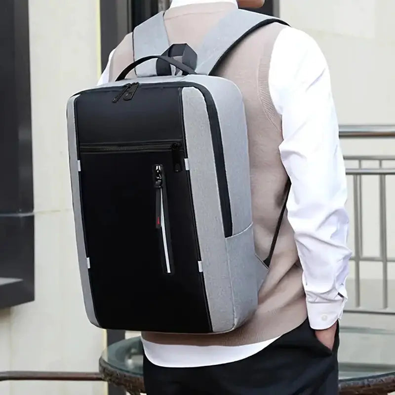 School backpack by Simples Market in gray with black front panel; versatile for business, industrial use and travel.