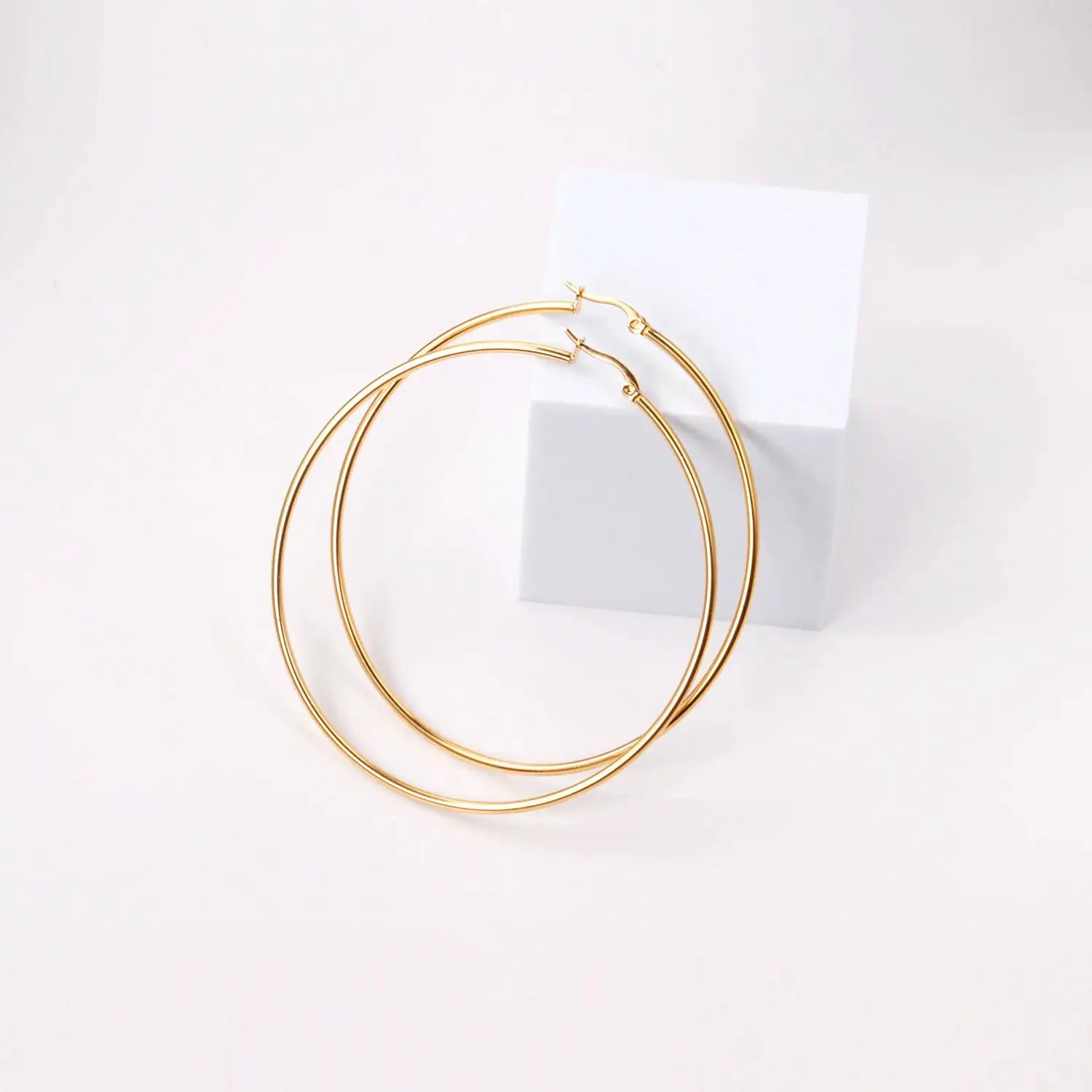 Pair of gold-tone stainless steel hoop earrings, unisex, large and small circular hoops