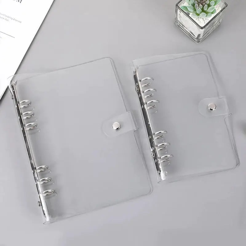 Two transparent plastic clip file binders (A5/A6) with metal rings and snap closures