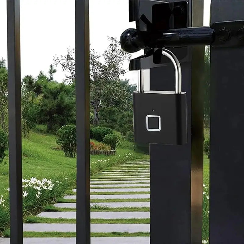 Keyless smart fingerprint padlock by Simples Market, black USB charging lock on a metal gate