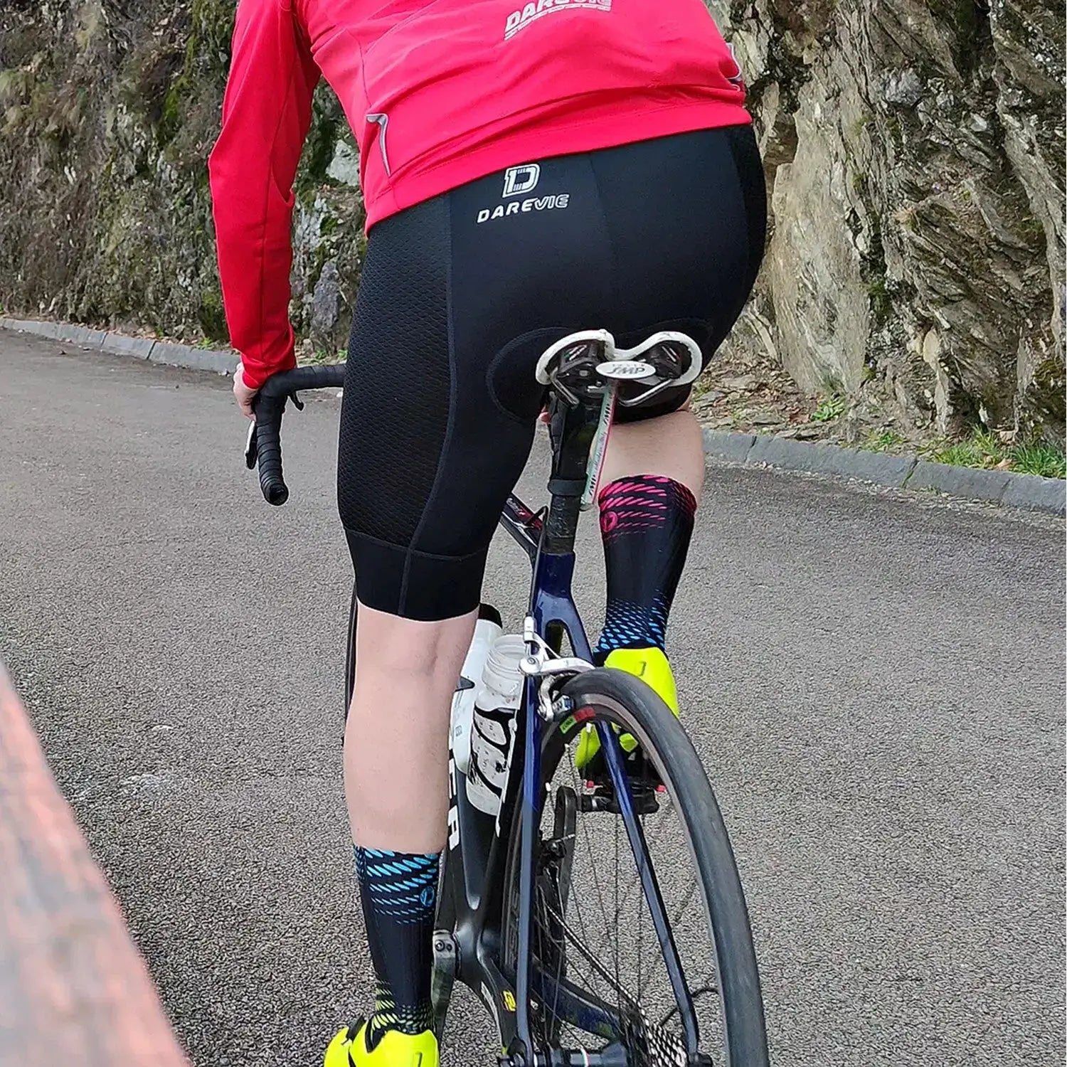 DAREVIE cycling bib shorts with logo, black breathable fabric on a cyclist