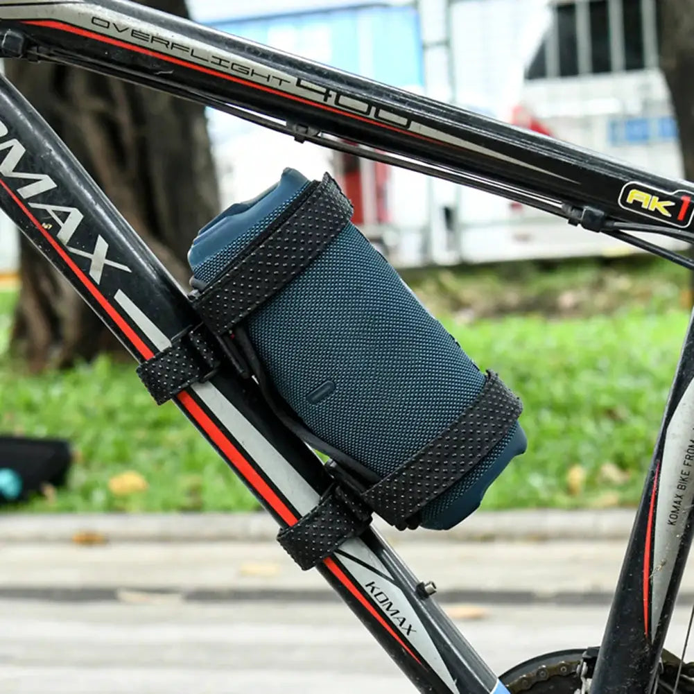 Bike speaker mount for JBL portable speaker; blue speaker secured to frame with black Velcro straps