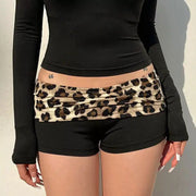 Booty shorts with leopard-print contrast waistband on black fabric; low-rise women's shorts