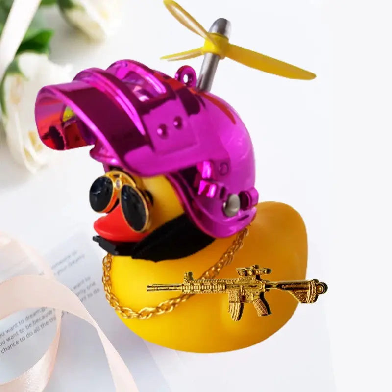 Yellow rubber duck car decor by Simples Market with purple helmet, sunglasses, gold chain and rifle pendant