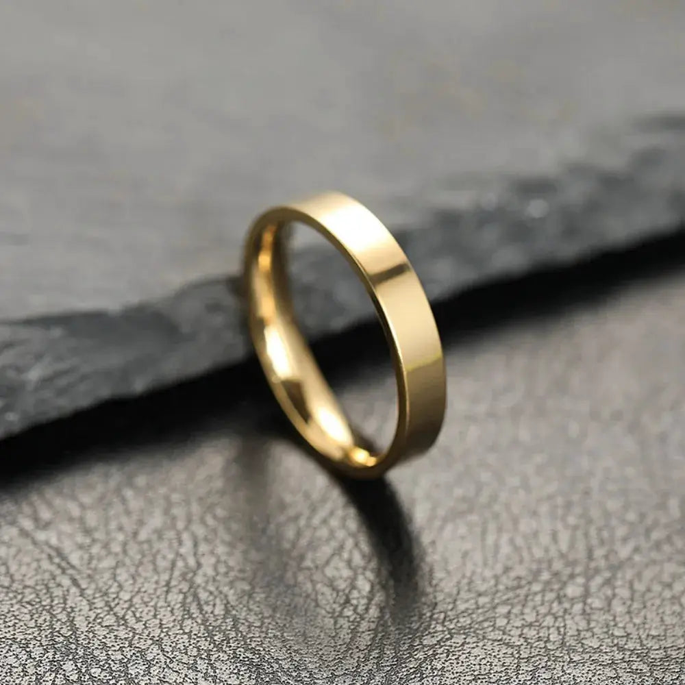 Gold-tone stainless steel ring with a smooth flat band, unisex fashion jewelry by Simples Market
