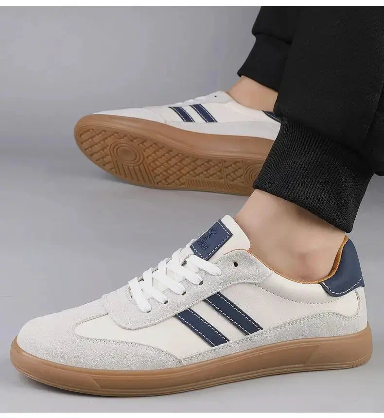 Men's casual sneakers with white upper, navy stripes, and tan gum sole