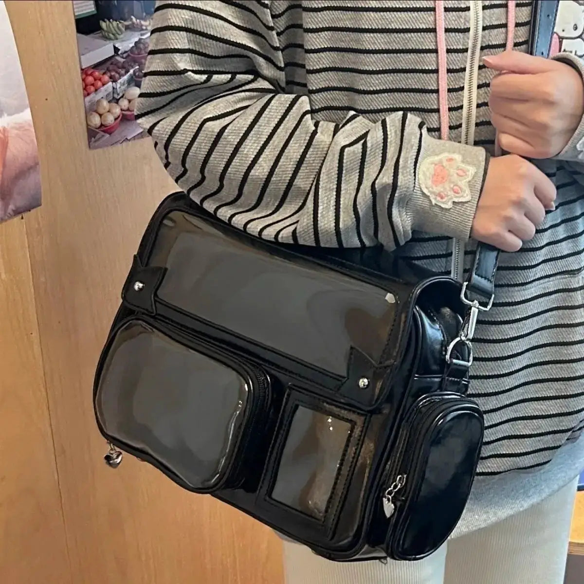 Ita bag crossbody backpack in black leather with clear front pockets and silver-tone hardware