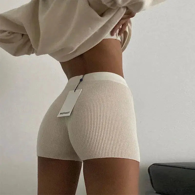 Beige high-waisted ribbed knit shorts for women with tag attached.